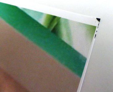 Intermittent staining on bottom corner of printed photographs and graphics.
