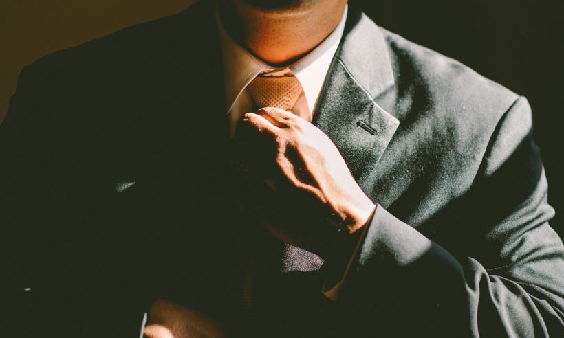 Chief executive officer (CEO) adjusting his tie and getting ready to work. (Credit: Free-Photos / Pixabay)