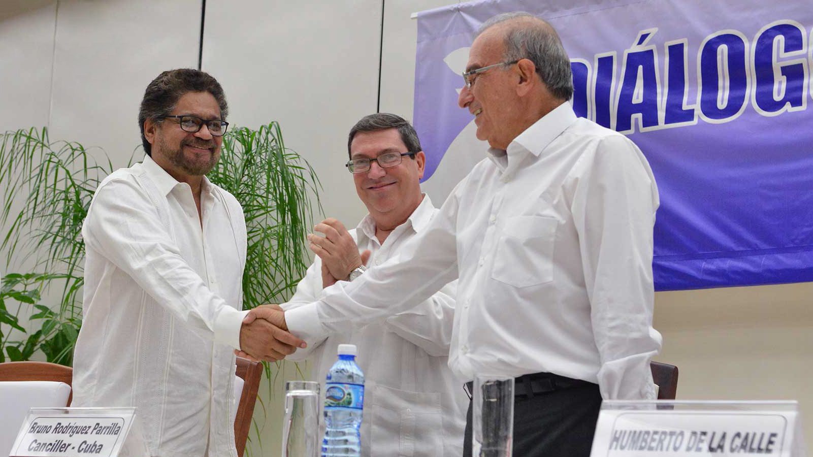 Chief peace negotiator for the Colombian government, Humberto de la Calle (right), shakes hands with FARC representative Iván Márquez in Havana, Cuba, to signify that a peace deal has been reached. (Photo credit: Presidencia de la República)