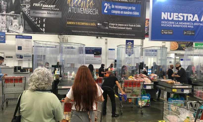 Above: PriceSmart has installed enclosures around cashiers to isolate them from shoppers during checkout, along with other safety measures. Pricesmart Medellín photo: Loren Moss