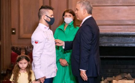 Juan Manuel Barrientos (left) receives the cross from President Ivan Duque