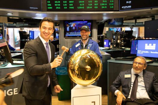 Tecnoglass CFO Santiago Giraldo on the NYSE floor with CEO José Manuel Daes, seated (Photo: Loren Moss)
