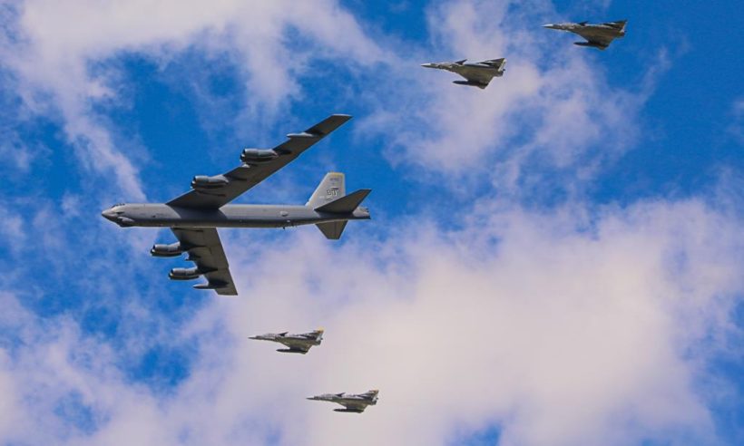 A USAF B-52 Stratofortress bomber flies in formation with Colombian Kfir fighters, commemorating the 100th anniversary of the founding of Colombia’s Air Force by the creation of a military aviation school for the Colombian Army in 1919 (photo © Loren Moss).
