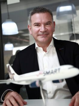 Estuardo Ortiz, CEO of JetSmart, in his office alongside a model plane.