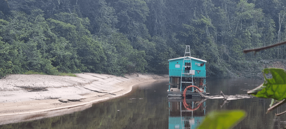 A dredging raft in the Pureté River at the tri-border.