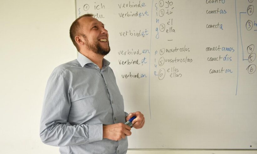 Mikhail Krasnov, a Russian-born academic who was elected mayor of Tunja, Colombia, in front of a classroom whiteboard.
