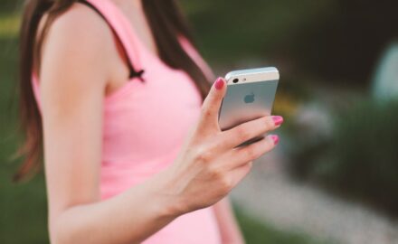 A user looks at their iPhone.