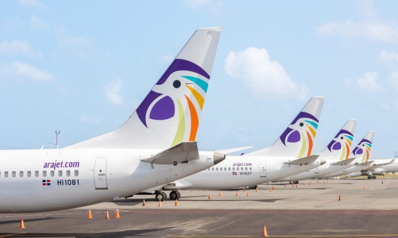 The tail of several Arajet planes at an airport