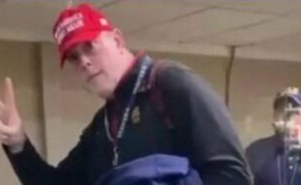 Deportee wearing dunce cap