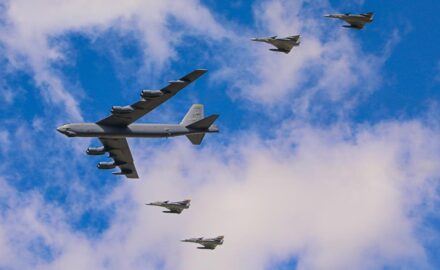 A USAF B-52 Stratofortress bomber flies in formation with Colombian Kfir fighters, commemorating the 100th anniversary of the founding of Colombiaโs Air Force by the creation of a military aviation school for the Colombian Army in 1919 (photo ยฉ Loren Moss).