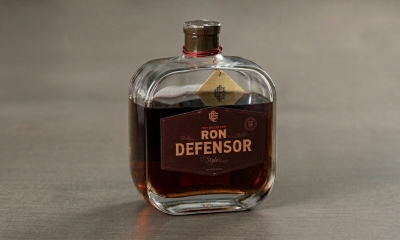 Bottle of Ron Defensor Style rum, 12-year aged, with a dark label and red cord around the neck