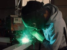A welder doing construction work within a factory.