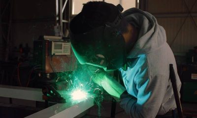 A welder doing construction work within a factory.