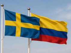 Flags of Sweden and Colombia waving together.