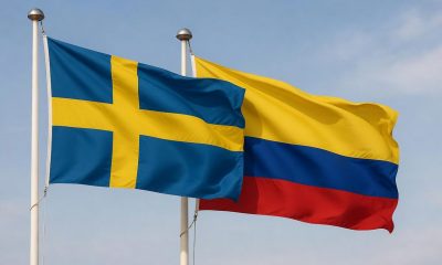 Flags of Sweden and Colombia waving together.
