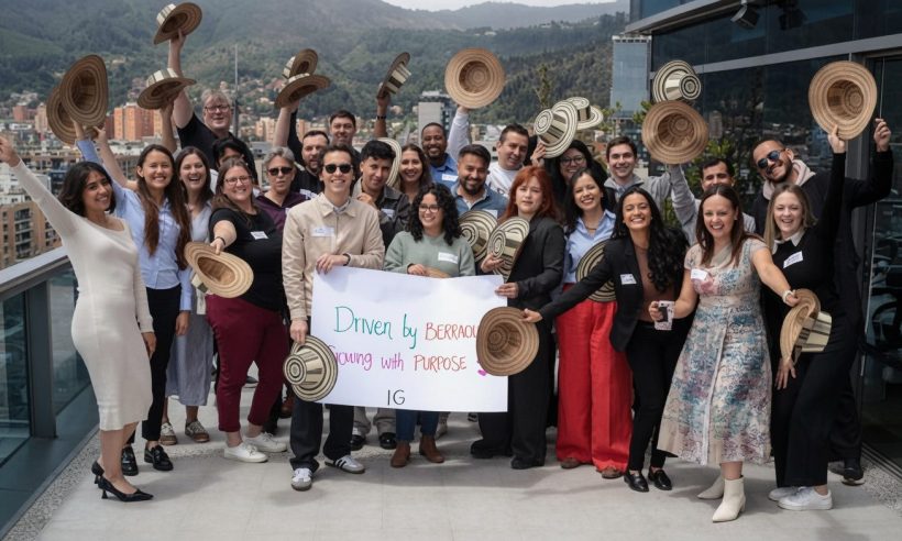 Insight Global professionals posing outdoors on a rooftop terrace, holding traditional Colombian hats and a banner that reads 'Driven by Excellence. (Photo: Insight Global)