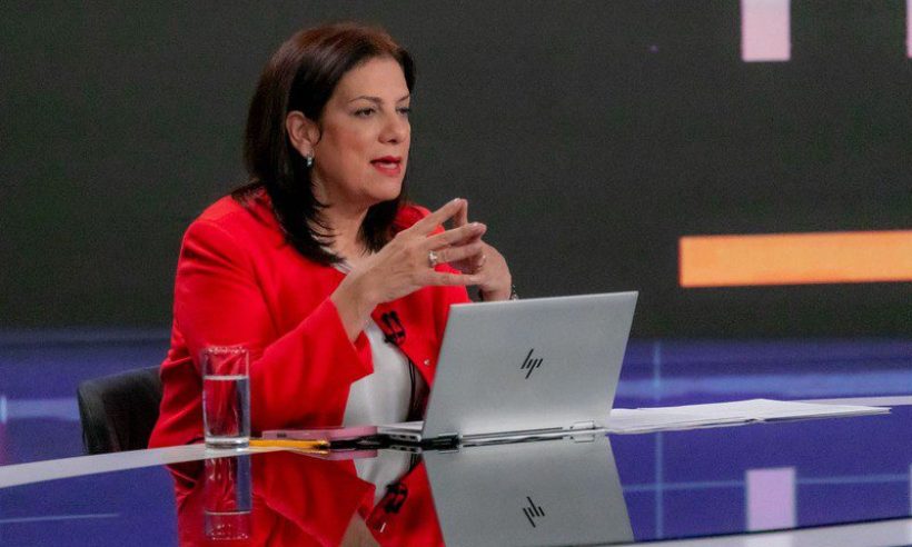 Colombia's ICT minister Alexandra Falla Zerrate speaks at a television studio desk in Bogotá