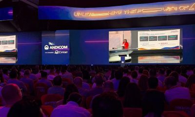 Audience in the ANDICOM 2026 hall in Cartagena watching Minister Alexandra Falla Zerrate on stage video screens