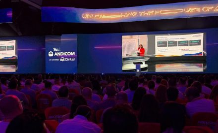 Audience in the ANDICOM 2026 hall in Cartagena watching Minister Alexandra Falla Zerrate on stage video screens