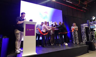 Organizers and guests cut a ribbon on stage at the Cinemotion Labs opening ceremony in Medellín, Colombia.