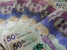Colombian 50,000-peso banknotes spread on a table