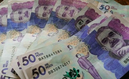 Colombian 50,000-peso banknotes spread on a table