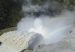 Water and mist pour through the spillway of the Hidroituango hydroelectric dam, with a rainbow in the spray