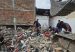 An excavator clears rubble as volunteers search the wreckage of a collapsed plastic bag factory in Pereira.