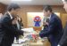 Colombia's trade minister and Japan's state minister of Economy, Trade and Industry shake hands in Tokyo