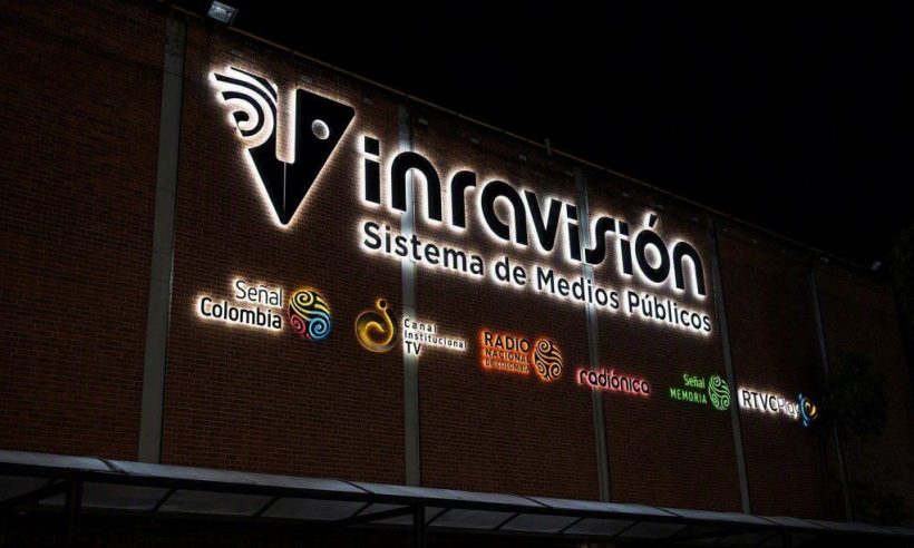 Illuminated Inravision public media system sign on its Bogota headquarters at night