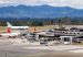 Aerial view of the José María Córdova International Airport terminal and apron in Rionegro, with mountains behind