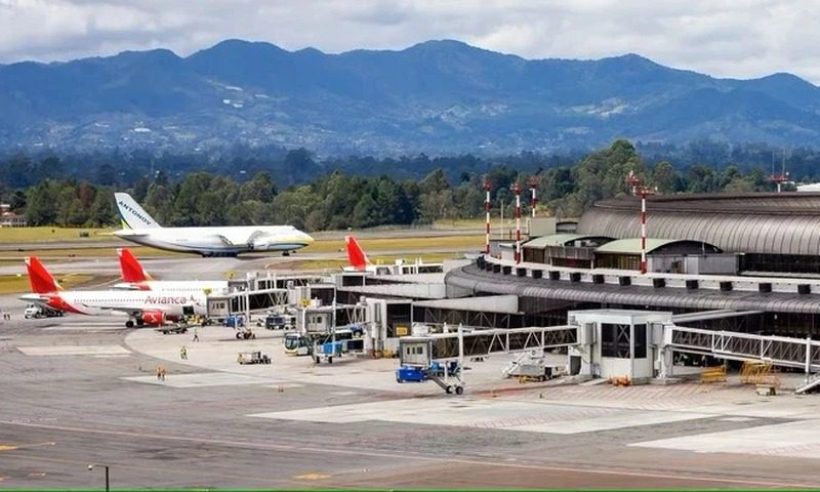 Aerial view of the José María Córdova International Airport terminal and apron in Rionegro, with mountains behind