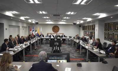 Delegates from Chile, Colombia, Mexico and Peru sit around a conference table at Mexico's Secretaria de Economia.