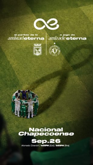 Players in a huddle on a soccer field beneath an infinity symbol and match details