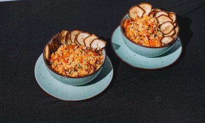 Bowls of Caribbean-style rice topped with fried plantain chips.
