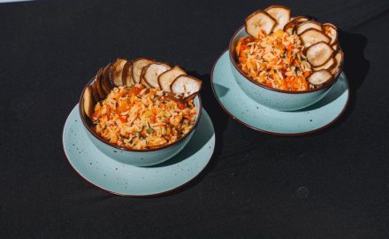 Bowls of Caribbean-style rice topped with fried plantain chips.