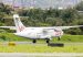 Clic ATR turboprop HK-5315 touching down on the runway at Olaya Herrera Airport, with Medellín hillside homes behind