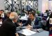 Business representatives talk across numbered tables at a trade fair matchmaking session with ProColombia table signs