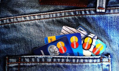 Credit and debit cards tucked into the back pocket of a pair of jeans.
