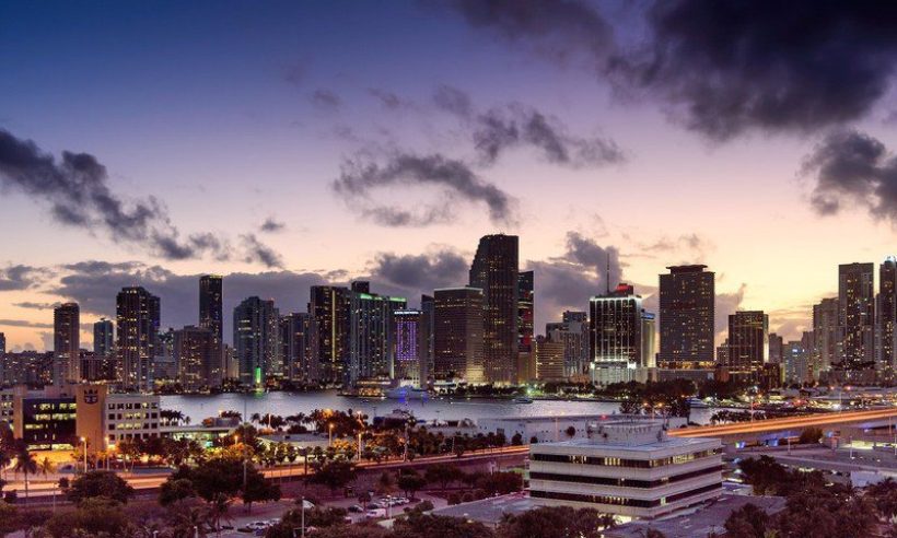 The downtown Miami skyline at dusk across Biscayne Bay