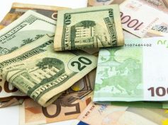 US $20 bills resting on euro and other foreign banknotes